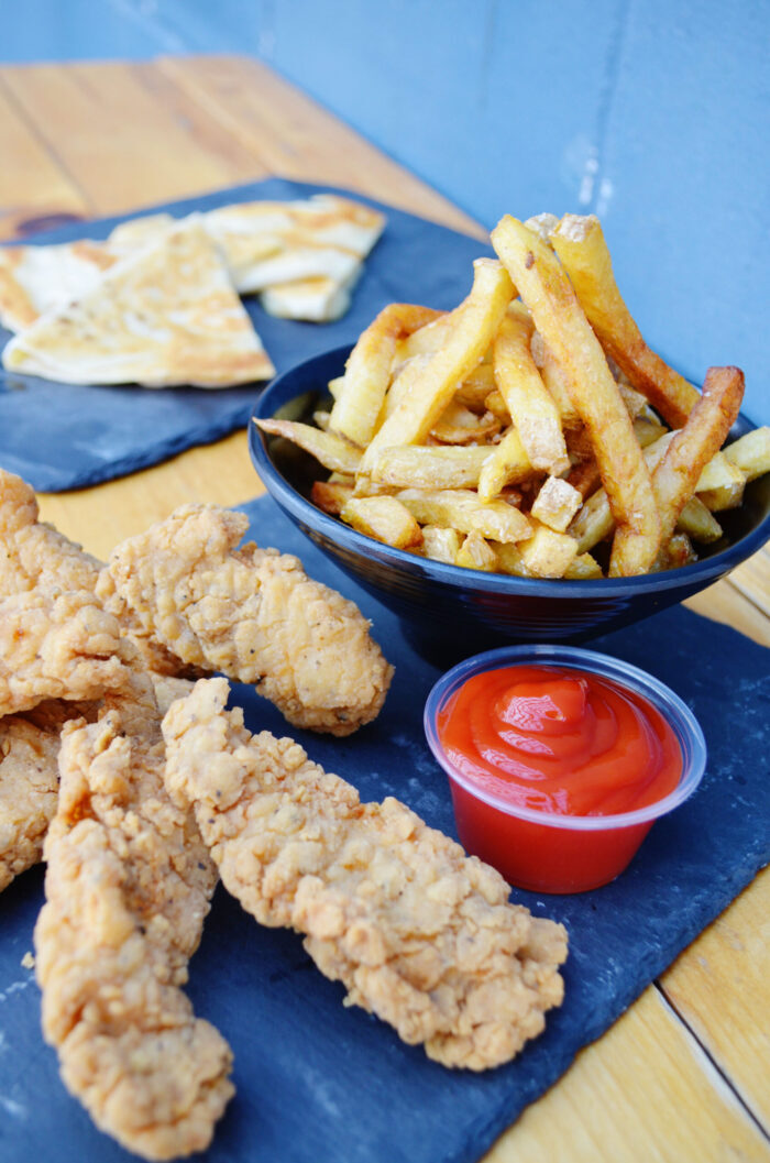 photo of different kid-friendly food we offer such as chicken nuggets, fries, and cheese quesadillas
